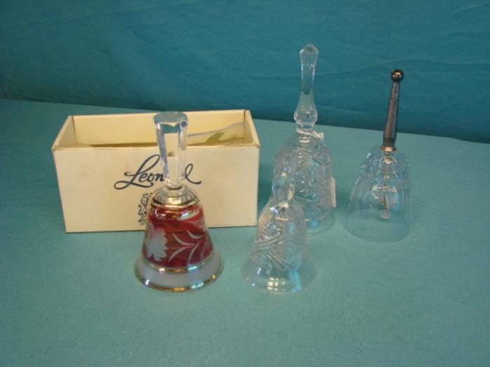 Five crystal bells; One Leonard hand-blown angel bell with original box, one princess house, two pressed crystal bells, and one cranberry and a frosted glass bell. All are in excellent condition, aside from one pressed crystal bell missing it's chime. Please see pictures.