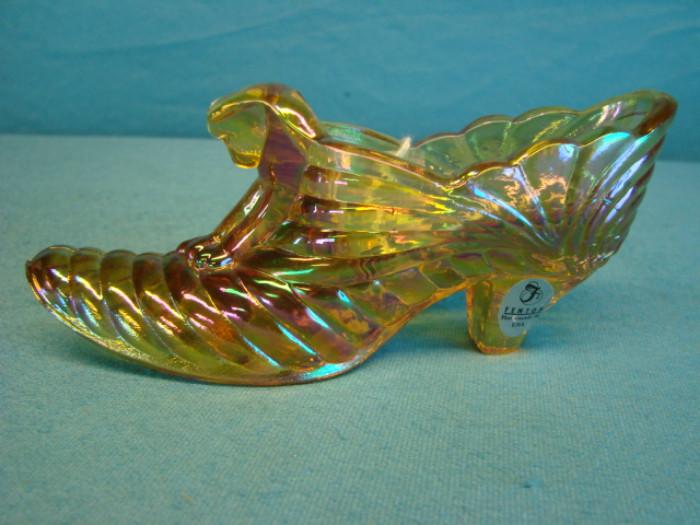 Beautiful Fenton marigold colored carnival glass shoe; Bottom is signed, and has original sticker. In excellent condition. Measures 6" long.