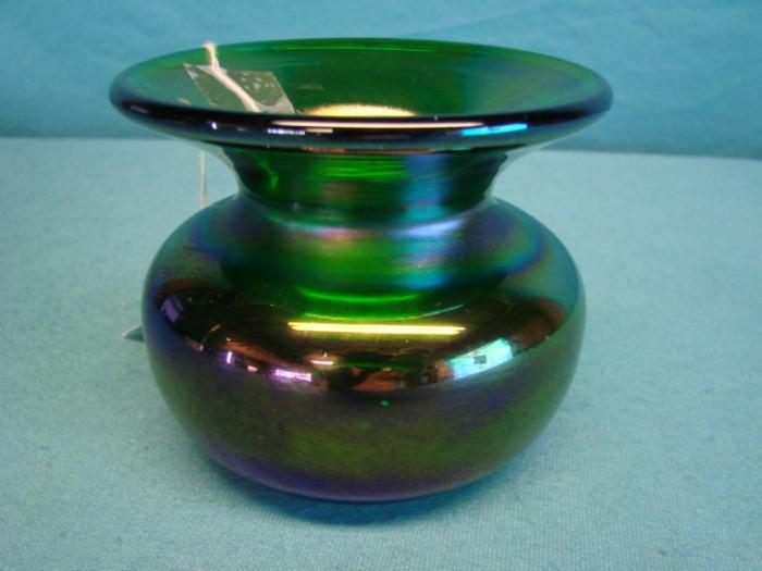 Green art glass vase; Beautiful deep green color, with a dark, heavy opalescent finish. Bottom is stamped, signed, and numbered "Gibson 182". Piece stands 3 1/2" tall. Has some very light wear, a few marks, no chips or cracks.