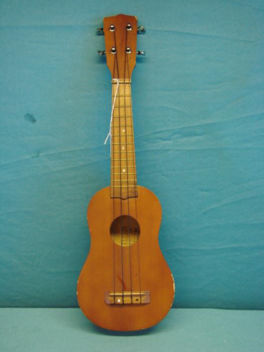 Very nice vintage ukulele; Purchased in Hawaii. Has some scuffs/scratches, some other light wear. Measures 21" long.