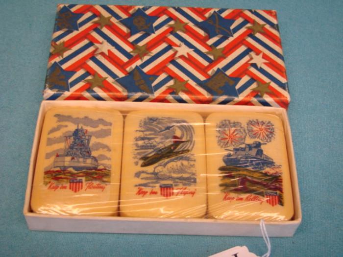 Very nice set of illustrated soap; Made in USA, WWII era. Each depicts a scene of a military branch. Each says "Keep 'em floating", "Keep 'em flying", and "Keep 'em rolling". Set is new in plastic, in original box.