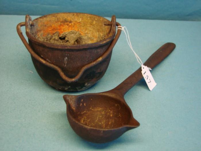 Hollins Ladle, Erie, PA, USA no.3 1/2 (Measures 15" long), and one small cast-iron melting pot, made by Clayton & Lambert, Louisville, KY, SA. Bowl has slag on the inside of it