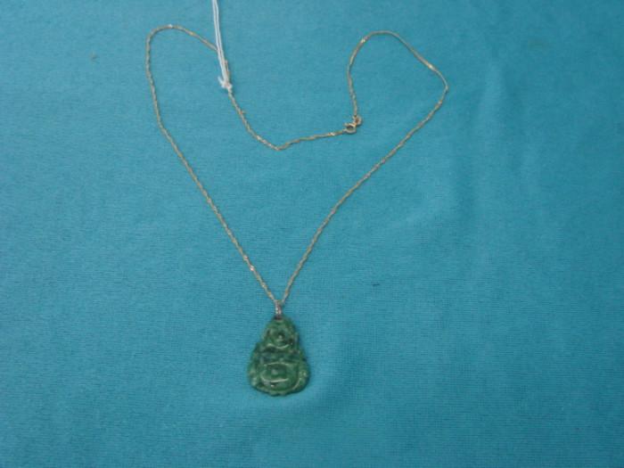 10 Yellow Gold Chain Necklace. Has a beautiful carved green jade Buddha pendant. Chain is 20" Long.