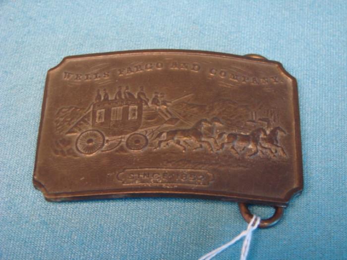 Wells Fargo solid bronze belt buckle. Rare, unique piece, made by Tiffany & Co., New York City, USA. Marked "Rare Stones". In very good condition, has some light wear from being worn, light dents on the back, and some very light oxidation. Buckle measures 3 1/2" x 2 1/4".