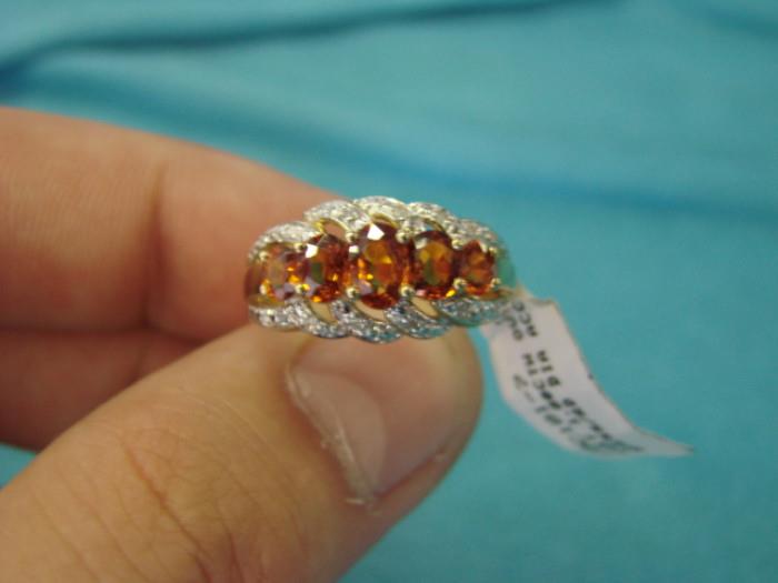 10 karat white and yellow gold ring, with 1.80ctw garnets, and diamond accents, size 7; Very sophisticated looking piece of jewelry, in immaculate condition Visit www.AuctionNV.com