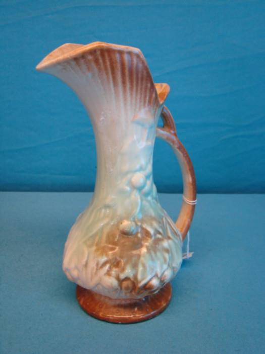 Beautiful vintage McCoy water pitcher; Appears to be depicting grapevines, some of the paint has fade, in otherwise excellent condition, no chips or cracks. Stands 8 1/2" tall.