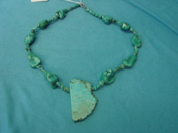 Unique blue turquoise colored howlite necklace; Very neat primitive look. Measures 20" long. In excellent condition.