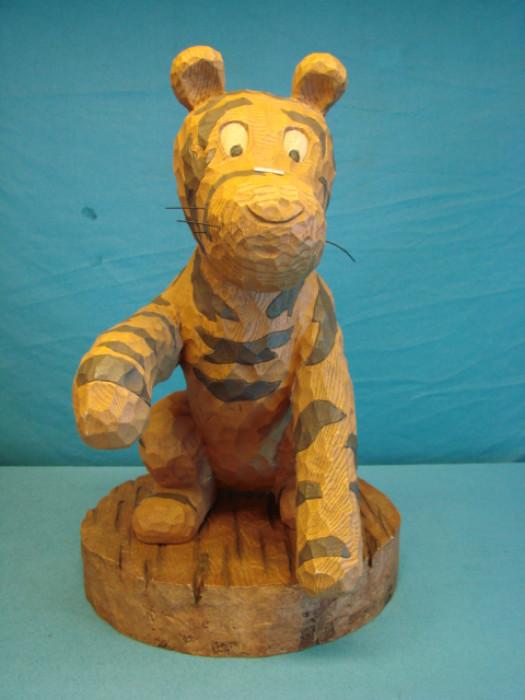 Very nice Tigger chainsaw cut-style wooden figure; Part of a 2001 limited series called "Big Fig" celebrating the 75th anniversary of Winnie the Pooh. Comes with matching base, marked on bottom. With base, stands 19" tall. Missing a few whiskers, and has two large cracks on the left arm, but is still very solid, and a great looking piece. Would make a great gift for any Winnie the Pooh fan.