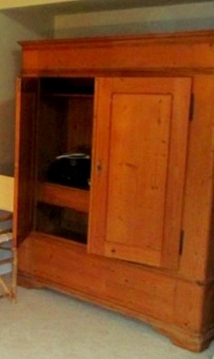 Solid wood entertainment center which may also be used as an armoir for clothes & shoes