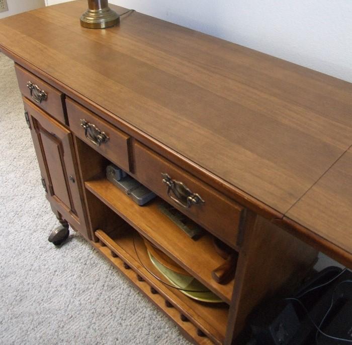 VERY NICE MAPLE SERVING CREDENZA THAT MATCHES DINNING SET AND CORNER HUTCH.