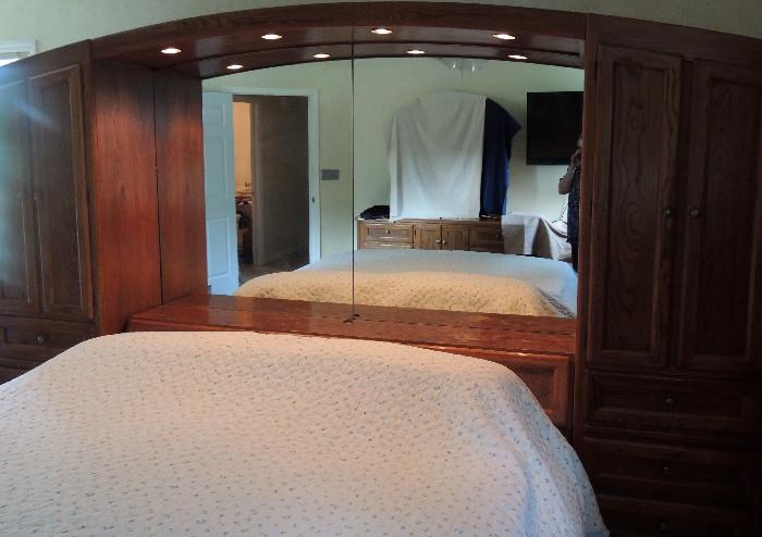 Storage unit/headboard/mirror from king-sized oak bedroom set. The mirror is flanked by storage closets, and there are additional drawers built in below the mirror. This comes apart for transport. Note-please see the next photo for a true look at the color finish of this set.