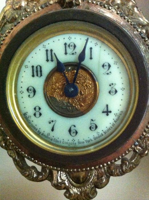 Antique Ansonia clock, basket style with hinged trinket box at base.