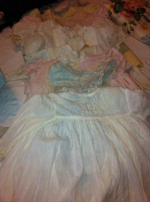 Several vintage baby dresses with smocking.
