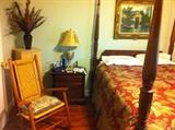 Mahogany queen size rice bed, oak rocker, cherry side table, Vincent in frame, pickled jewelry case, decorative lamps.
