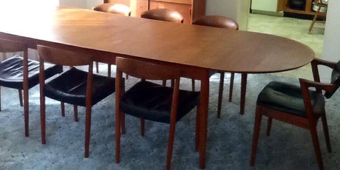 Solid mid century modern teak table and 8 chairs made in Denmark.  Table is rectangular until you attach the two leaves on each end then it becomes a racetrack shape. 