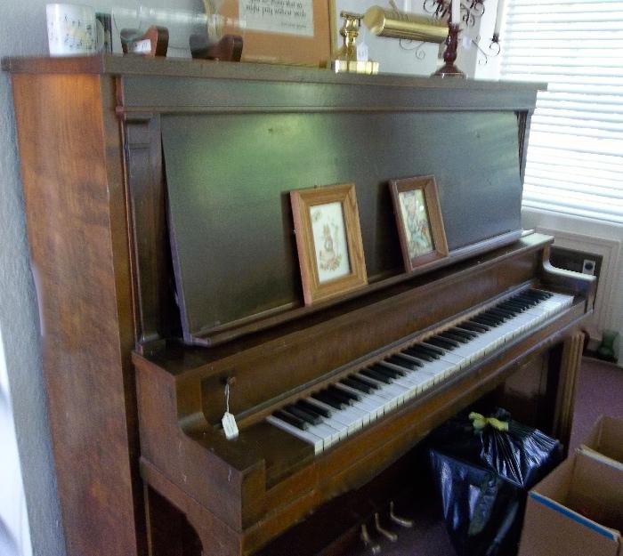 Upright "teaching" piano in sunroom/studio.  Good buy!  Wish it could talk...many, many folks learned to love music right here!