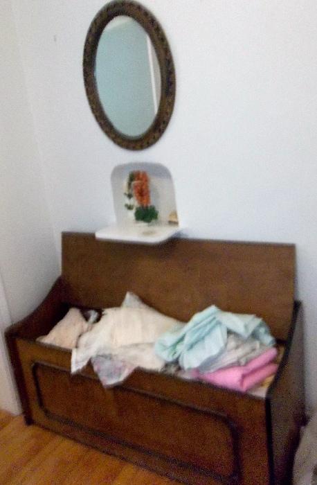 Nice oval mirror over handcrafted storage chest - full of linens!