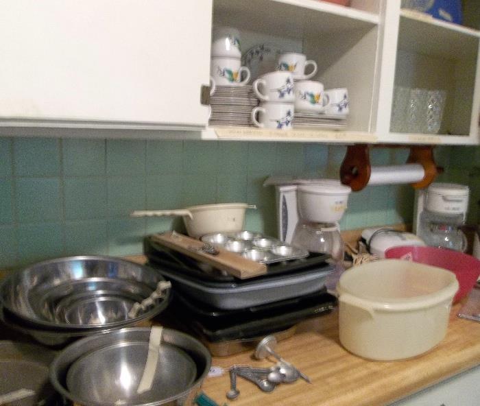 Nice breakfast set in cabinet and some nearly new prep pans/bowls on countertop.