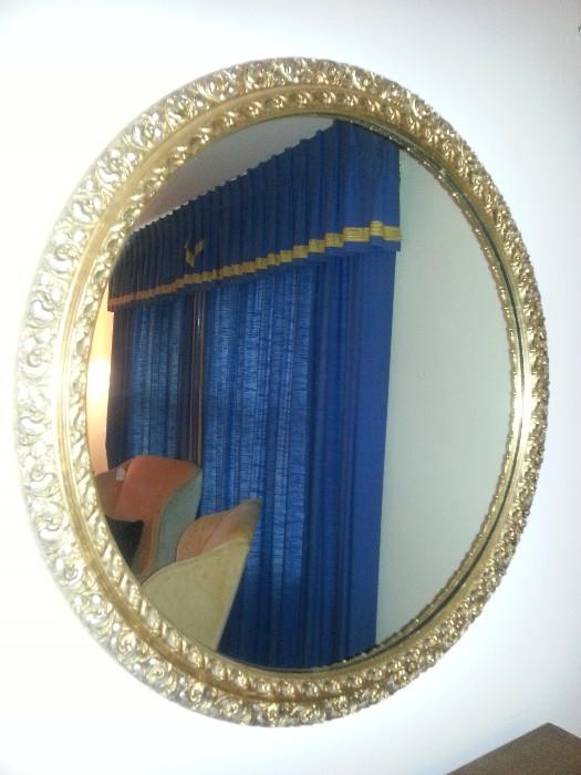 Vintage, round gold gilt, ornate, wooden mirror.
