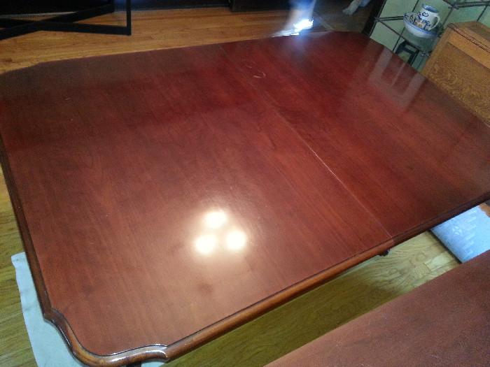 Gorgeous dining room table, comes with two leaves and custom pads. It sits on two beautifully carved pedestals and comes with four chairs. It also has a matching sideboard. 