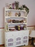Charming white painted hutch bookcase with lavender fabric panels