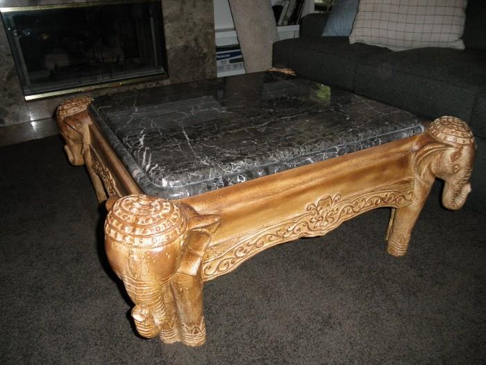 marble top coffee table with carved elephant legs