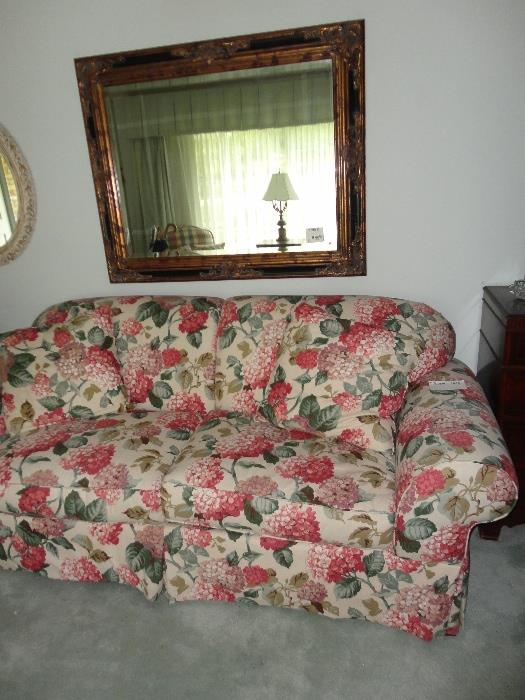 Floral upholstered couch, mirror