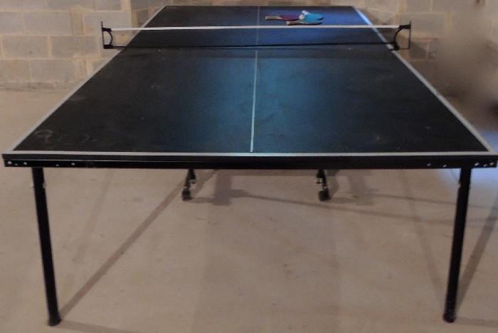 Ping pong table, fold and roll away for storage.