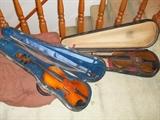 Violins with cases attributed to Francois Lejeune (left) and Antonius Stradivarius (right)