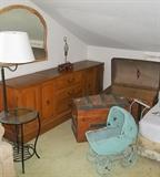 Contemporary lamp table, long dresser with mirror, 2 antique trunks and vintage wicker doll buggy.
