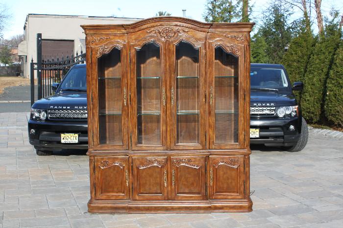 ITEM # 1029Presented here is a wonderfully designed Drexel Heritage Fine China Cabinet. It is evident that elegance and sophistication went into the design of this cabinet. The intricate top molding and hand engraved doors, are nuances which set this piece aside from others. Storage capacity for all your fine china is plentiful due to the vast amount of space provided from the three level shelving. The glass shelves add to the inside attractiveness of this piece. Each shelf can be easily removed, for ease of transportation of this unit. The unit is composed of two pieces. The entire "top glass door section" of this cabinet, lifts off the "storage bottom section", which also allows for a much simpler and safer move. Originally this cabinet sold for: $2,800.00. This piece is part of a complete dining room set that we have available for sale which includes a "Complete Dining Room Table & Chair Set", "Mirror" and a "Hallway Stand". If you are interested in these matching items please vie