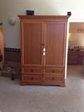 Master armoire holds a tv very large and sturdy 