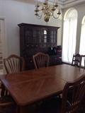Dining room table beautiful with two extensions and covers along with a hutch 