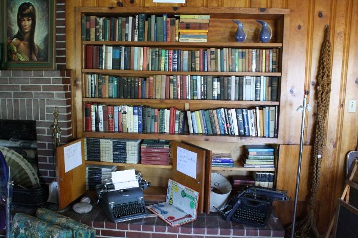 Many books and vintage typewriters