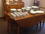 Very nice drop leaf maple table.  Perfect for smaller spaces.  Nice solid white dinner ware too