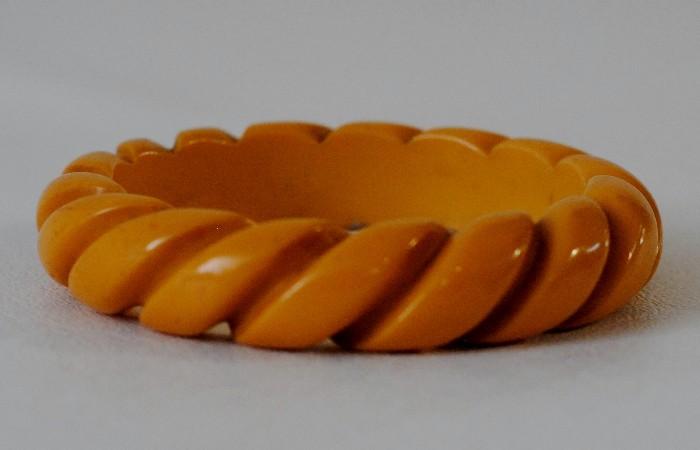 Bakelite Bangle - Yellow  Bakelite bangle with carved detailing in a curving striped motif
