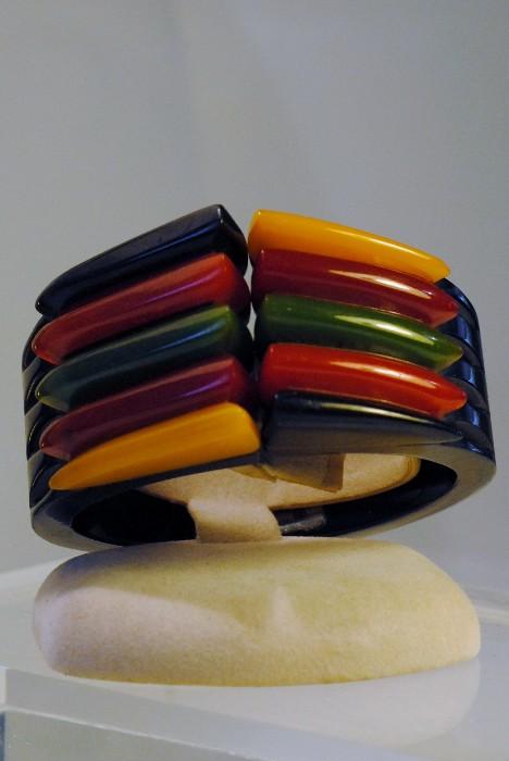 Bakelite snap bracelet - Black colored Bakelite bracelet, with snap close, and having red, yellow, amber, green  and black Bakelite triangle design.
