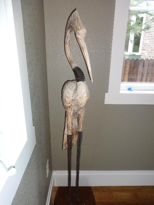 Crane on a stand  - wood - 4 ft high - This lovely wood piece fits nicely in any corner of a room.  The finish is weathered with a carved body and iron coiled neck.
