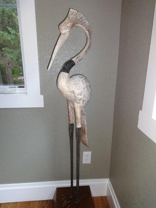 Crane on a stand  - wood - 4 ft high - This lovely wood piece fits nicely in any corner of a room.  The finish is weathered with a carved body and iron coiled neck.
