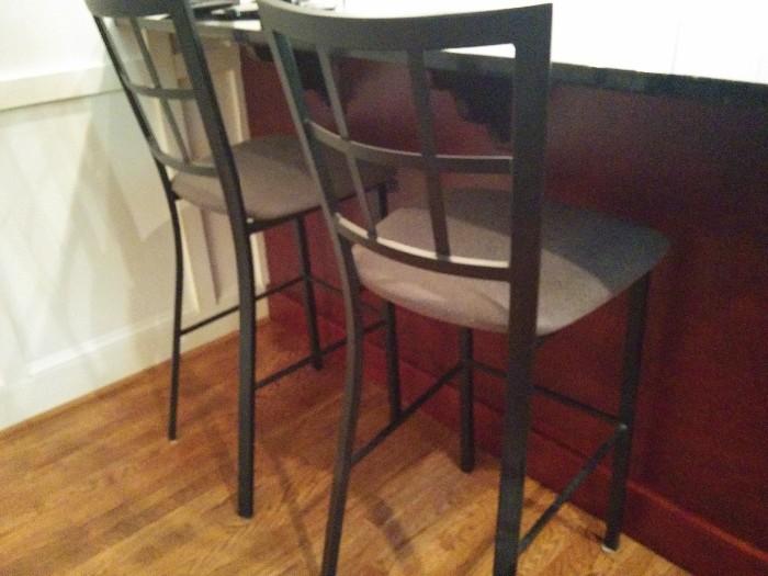 Pair of black metal barstools, with upholstered seat cushions, made in Canada
