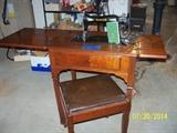 Singer 15-91 elec. sewing machine with all attachments and storage bench