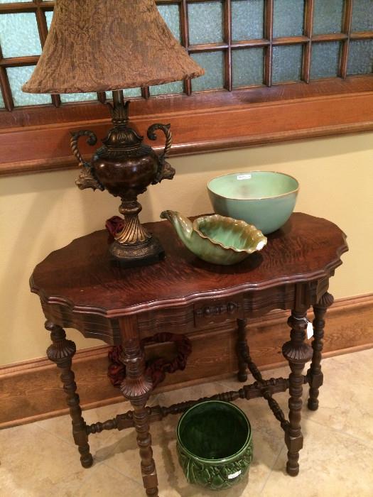       Antique table; 1 of many lovely lamps; pottery