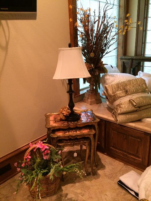 Stacked tables; 1 of about 20 lamps; bedding; floral arrangements