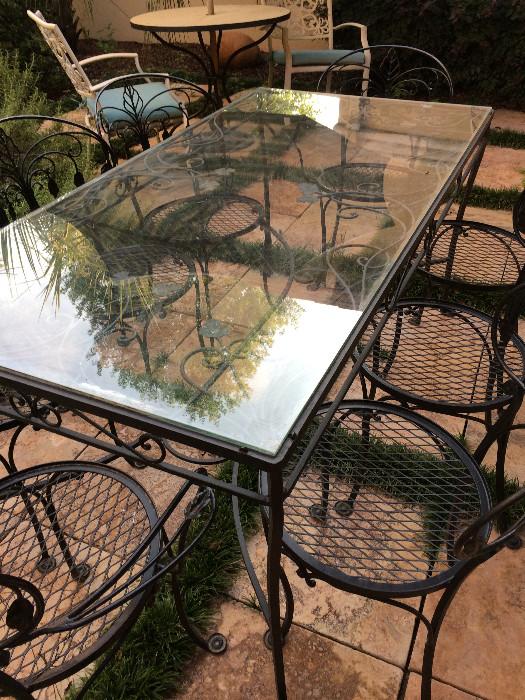 Exceptional glass top table with 8 matching rounded-back chairs
