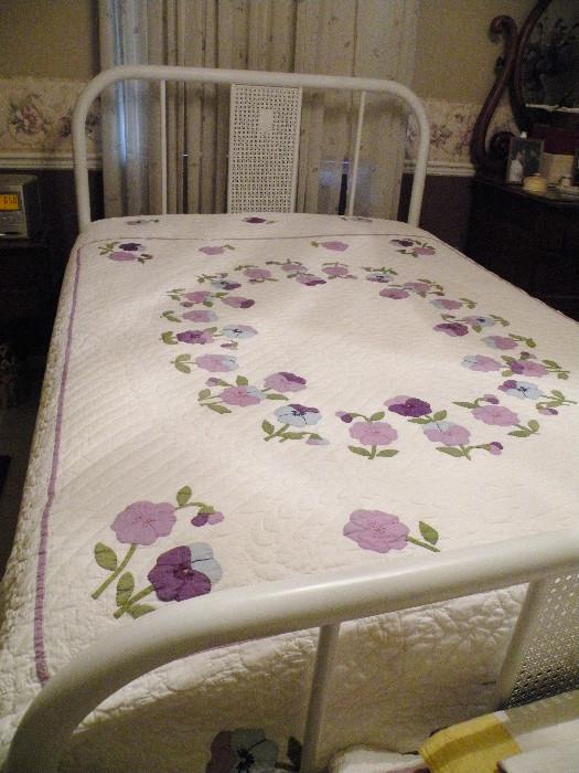 Pretty purple pansies on a full size bed