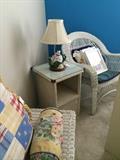 White wicker trunk, side table, & chair; teapot lamp; decorative pillows