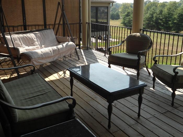 Other side of outdoor area that is covered...Large Glas Grill, Coffeetabpe, end table, Love Seat, 2 matching chairs. and large swing....Also you can see the outdoor divider...