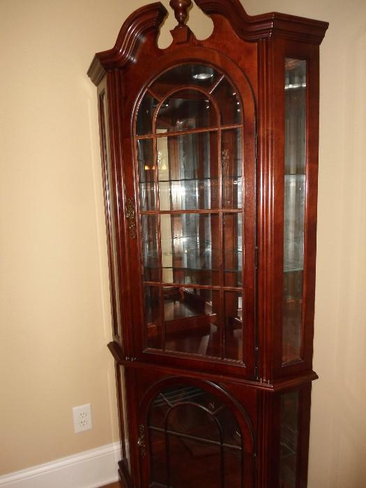 Corner China Cabinet.  Corner piece 25 inches deep.. with light, glass shelves top and bottom below....Like NEW...Very elegant..Great way to display your collections, china, glassware....