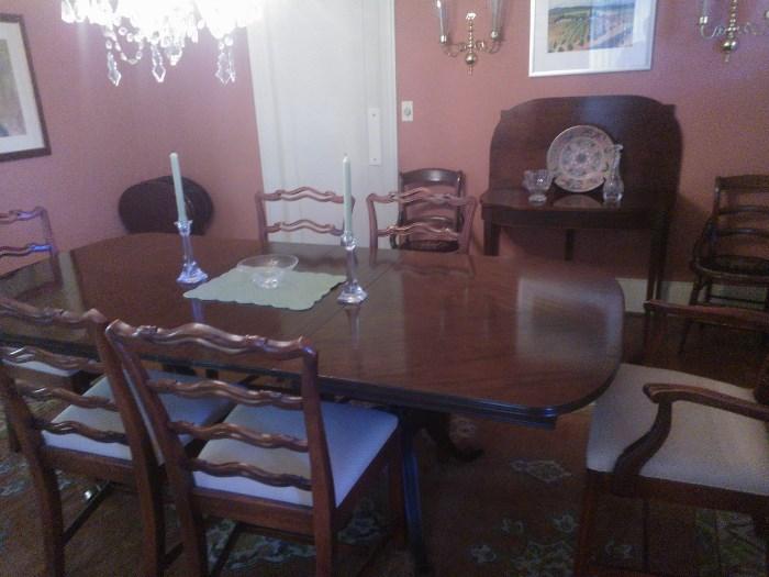 Dining table with six chairs - beautiful mahogany finish.  It measures 44" wide x 62" long with no leaves inserted ad 29"h, three 12" leaves extend the table to a full length of 98" or varying lengths in between.  Art and accessories not for sale