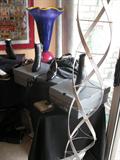 Tables of designer accessories, with art glass vase in back